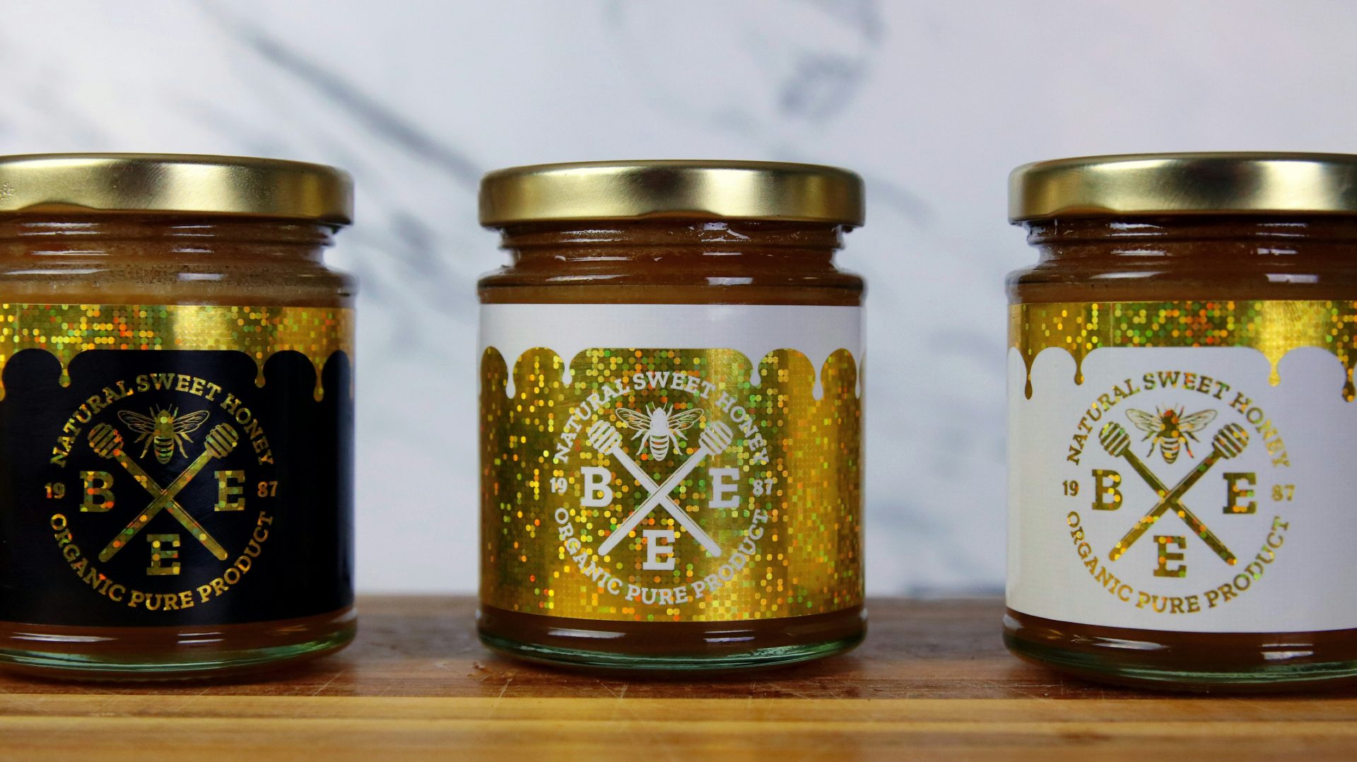 a group of jars with gold labels